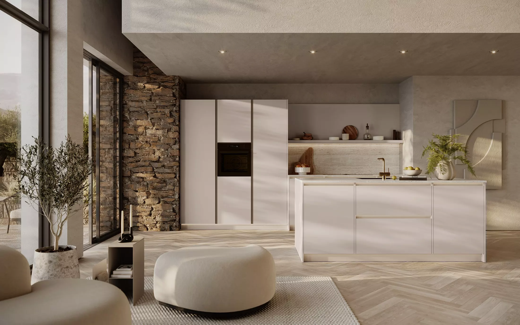 Cuisine Rotpunkt lumineuse avec îlot blanc, colonnes intégrées, mur en pierre naturelle et grande baie vitrée.